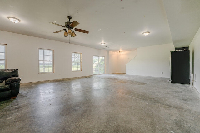 interior space with ceiling fan and concrete flooring