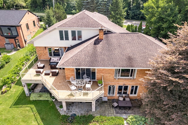 rear view of property with a lawn, a patio, and an outdoor hangout area