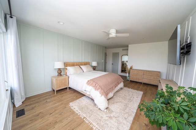 bedroom with ceiling fan and hardwood / wood-style floors