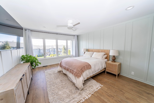 bedroom with ceiling fan and light hardwood / wood-style floors