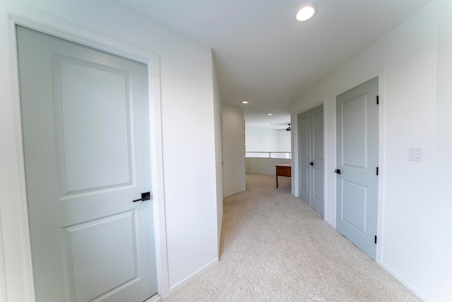 hallway featuring light carpet