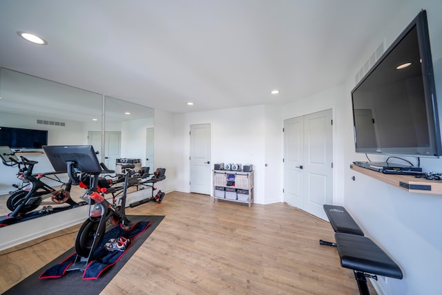 workout area featuring light wood-type flooring