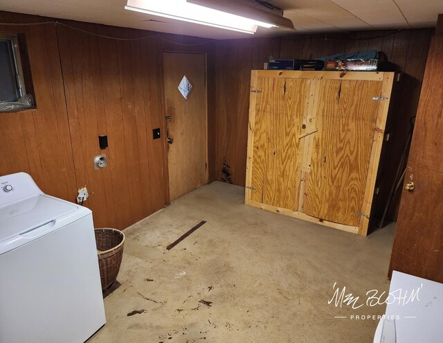 washroom featuring washer / dryer and wooden walls