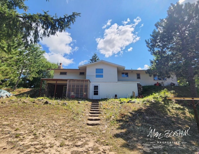 back of property featuring a sunroom