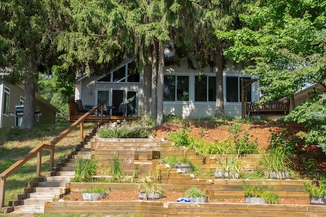 rear view of house featuring a sunroom