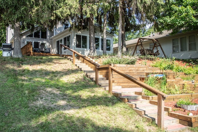 view of yard featuring a deck and stairs