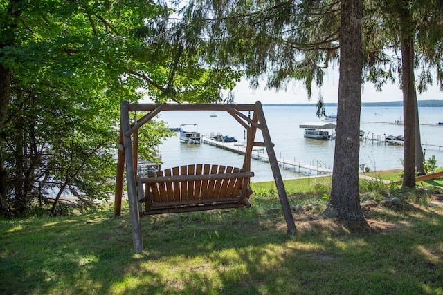 view of yard with a dock and a water view