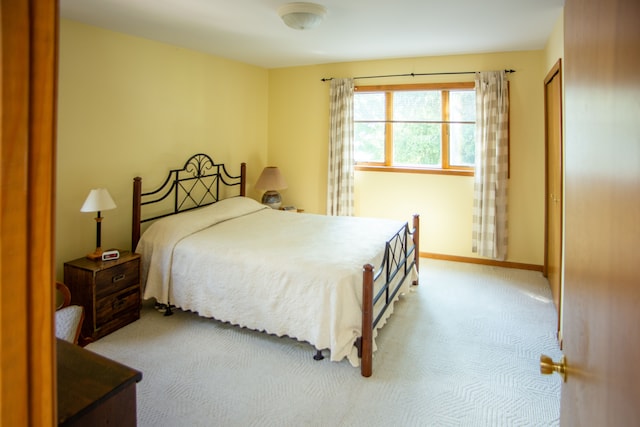 carpeted bedroom with baseboards