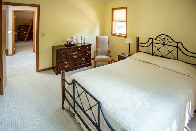 bedroom featuring carpet and baseboards