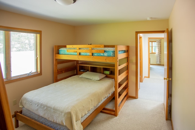 bedroom featuring carpet and baseboards