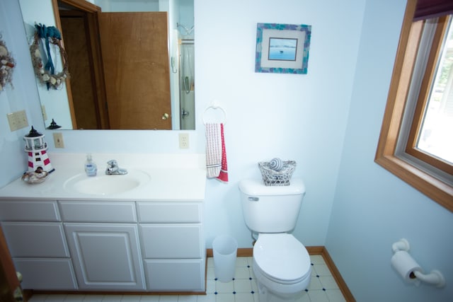 bathroom featuring tile patterned floors, vanity, toilet, and baseboards