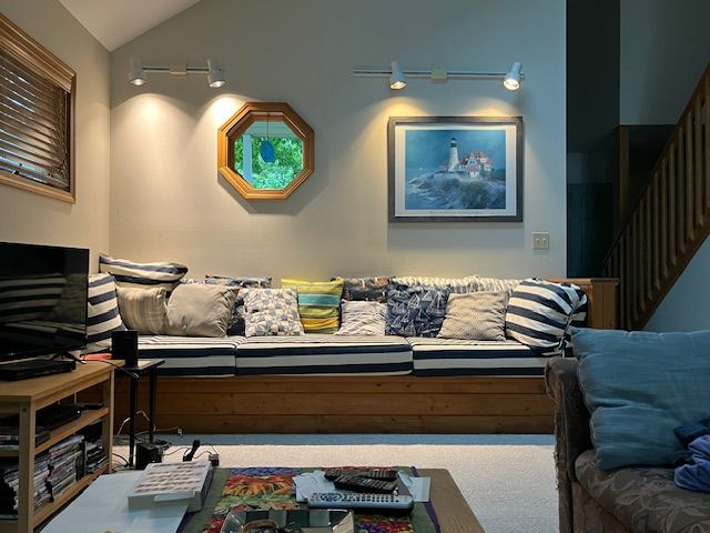 home theater room featuring lofted ceiling and carpet flooring