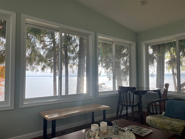 sunroom with a water view and vaulted ceiling