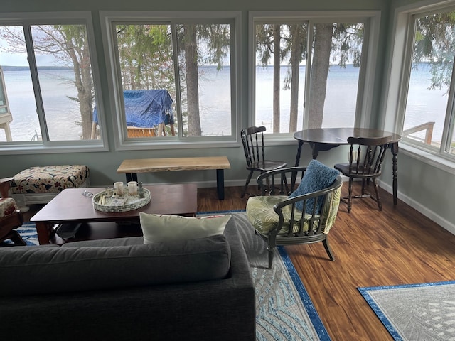 sunroom / solarium with a water view and a wealth of natural light