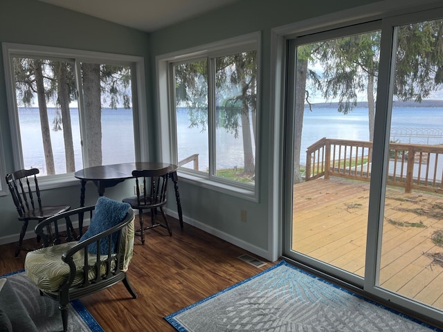 sunroom with a water view and visible vents