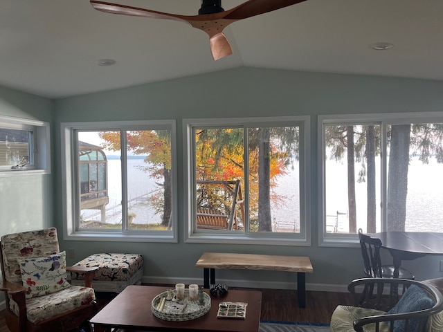 sunroom with a ceiling fan and vaulted ceiling