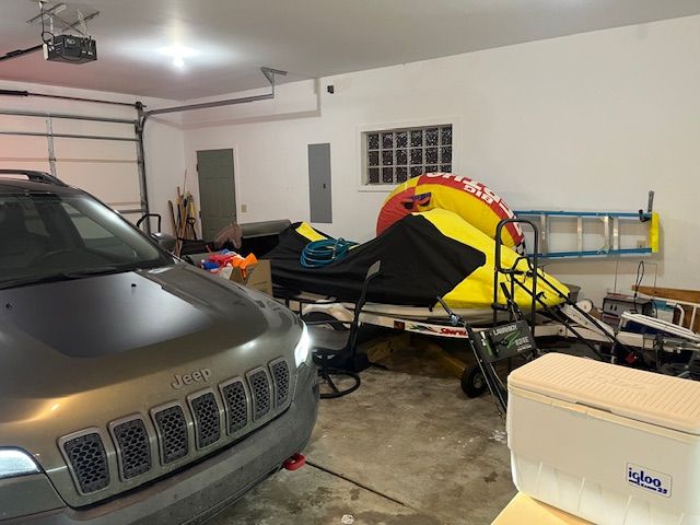 garage with electric panel and a garage door opener