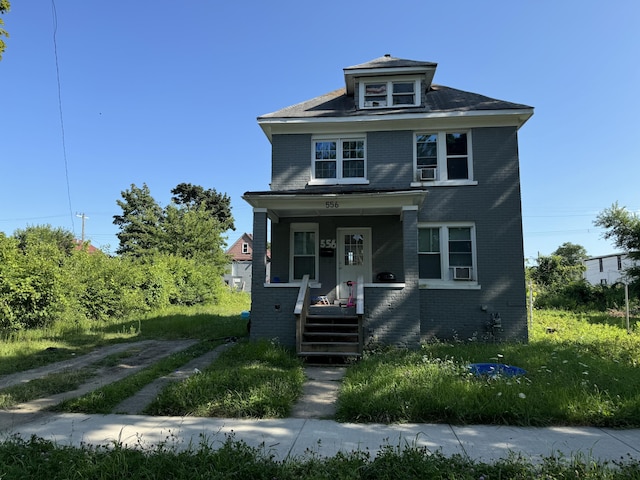 556 Leicester Ct, Detroit, MI 48202 - american foursquare style home with brick siding, covered porch, and cooling unit