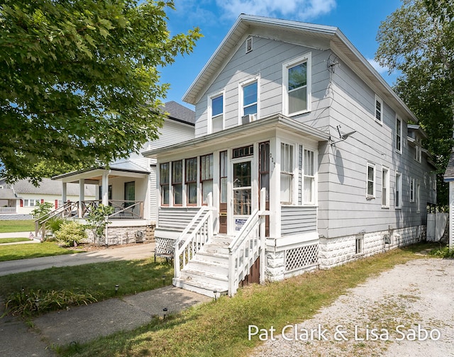 view of front of house with a sunroom and covered porch