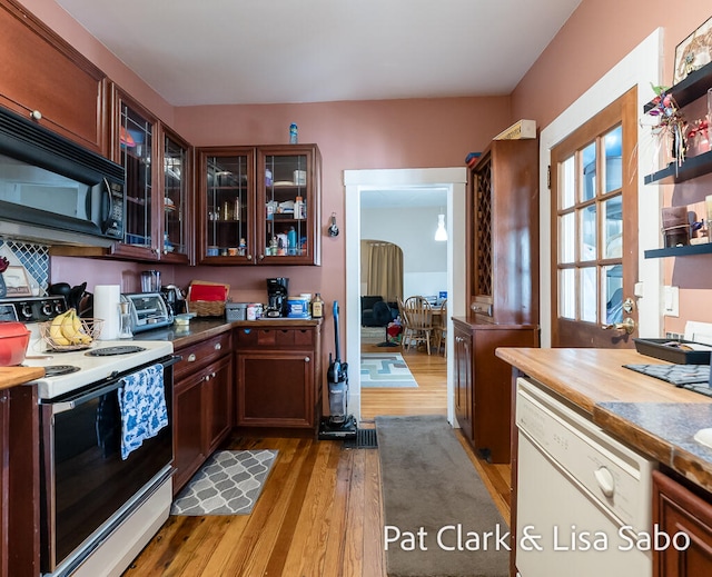 kitchen featuring white appliances and light hardwood / wood-style flooring