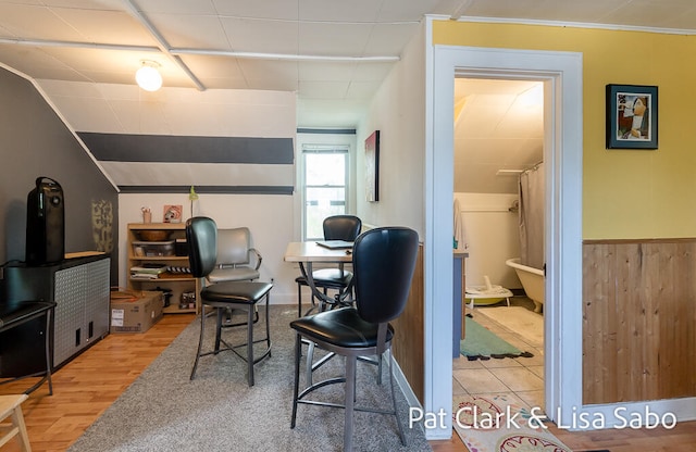 home office with hardwood / wood-style floors and wood walls