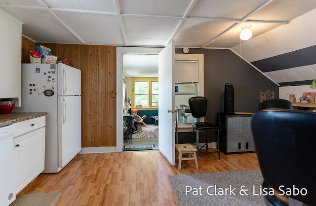 interior space featuring wood walls and light hardwood / wood-style floors