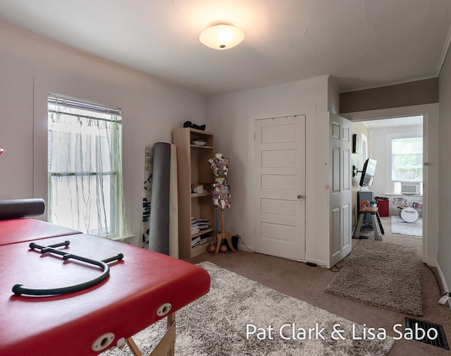 carpeted office space with cooling unit and crown molding