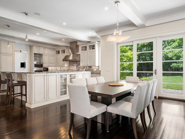 dining area featuring beamed ceiling, dark hardwood / wood-style floors, and ornamental molding