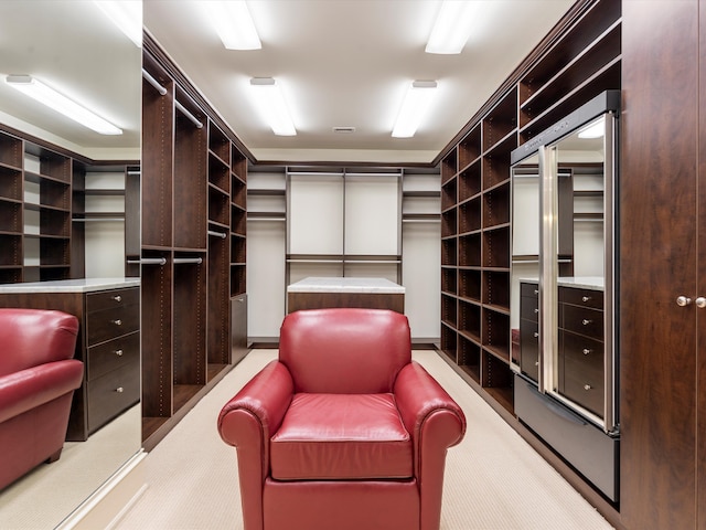 walk in closet featuring light carpet