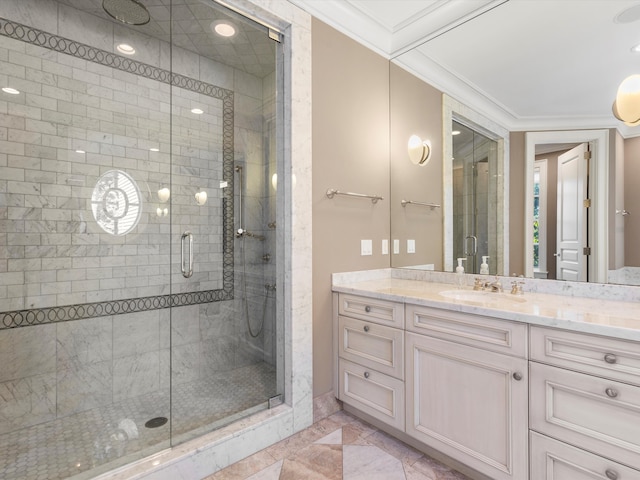 bathroom with vanity, a shower with door, and crown molding