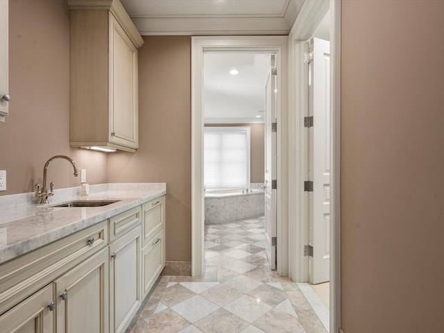 interior space with a relaxing tiled tub, ornamental molding, and vanity