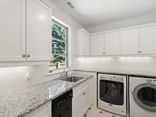 laundry room with washer and dryer, light tile patterned floors, and sink