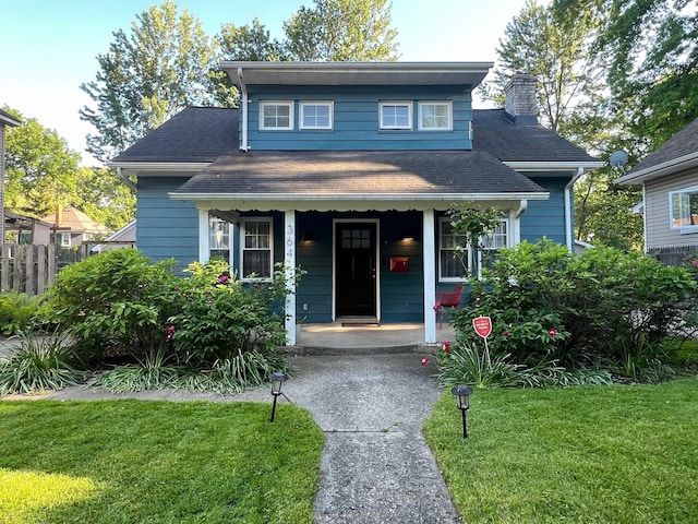 view of front of home with covered porch and a front yard