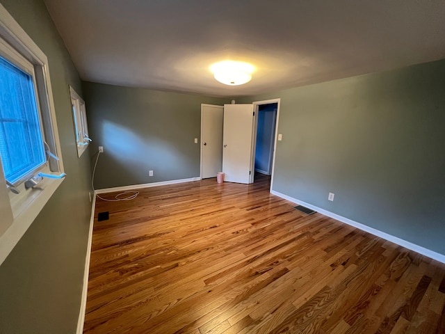 unfurnished room with light hardwood / wood-style floors