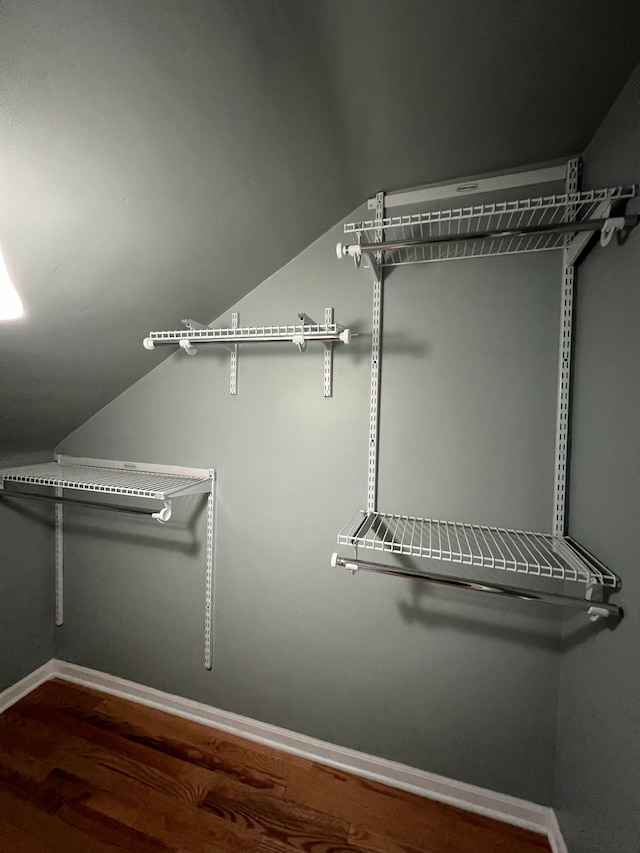 walk in closet featuring lofted ceiling and wood-type flooring