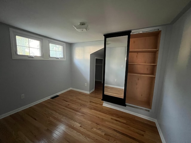 unfurnished bedroom with wood-type flooring