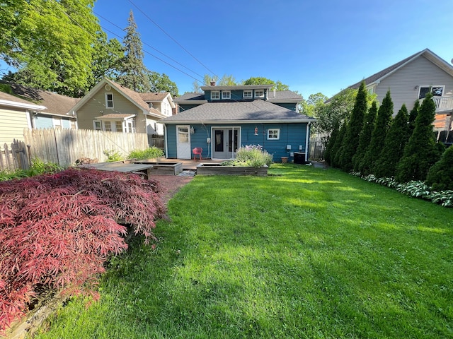 back of house with a yard and central AC unit