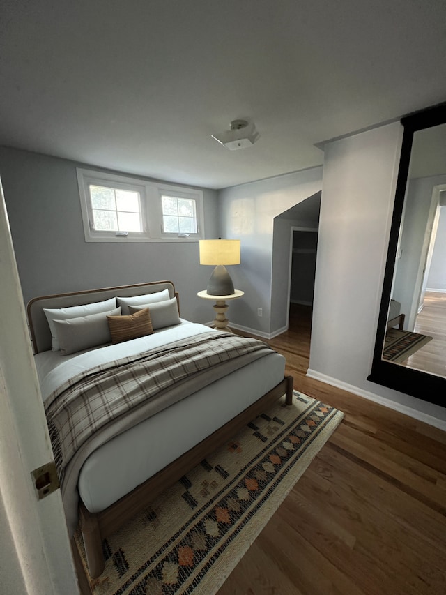 bedroom with hardwood / wood-style flooring