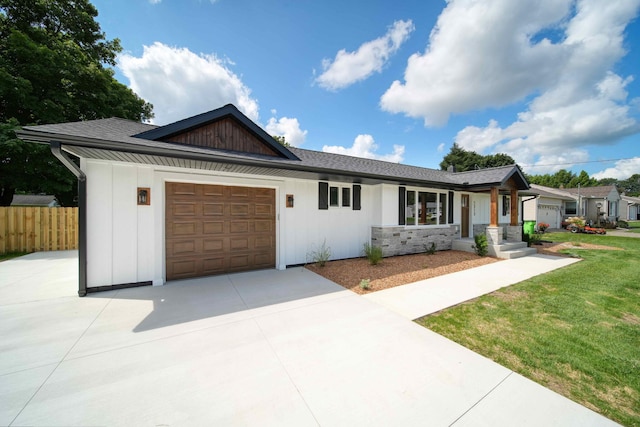 single story home with a front yard and a garage