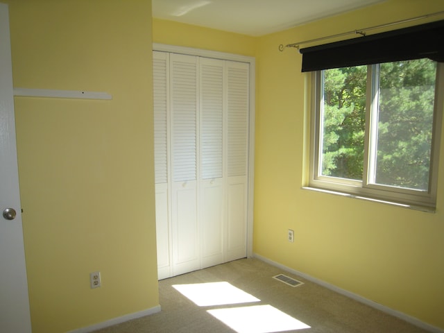 unfurnished bedroom featuring carpet floors and a closet