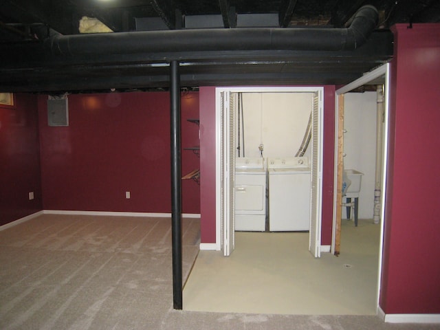 basement featuring washer and dryer, carpet flooring, and electric panel