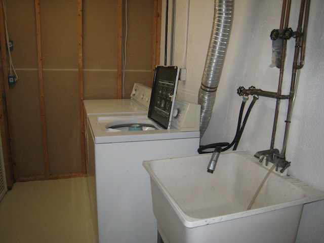 laundry area featuring independent washer and dryer and sink