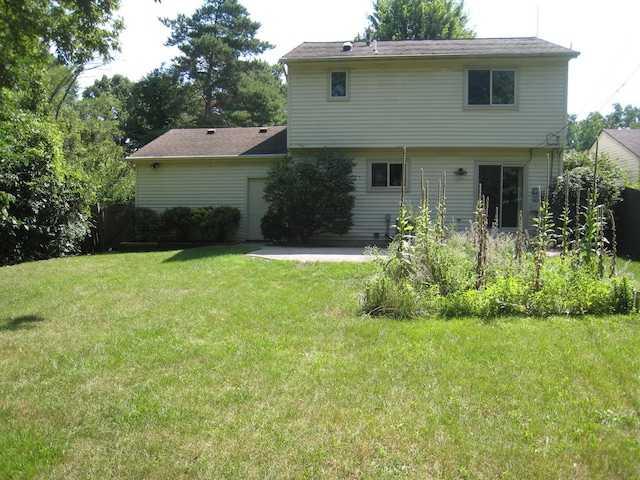 back of house featuring a yard and a patio