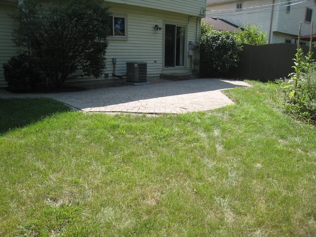 view of yard featuring a patio and central air condition unit