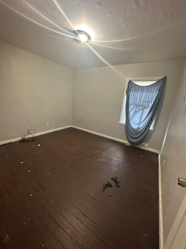 bonus room with dark wood-type flooring