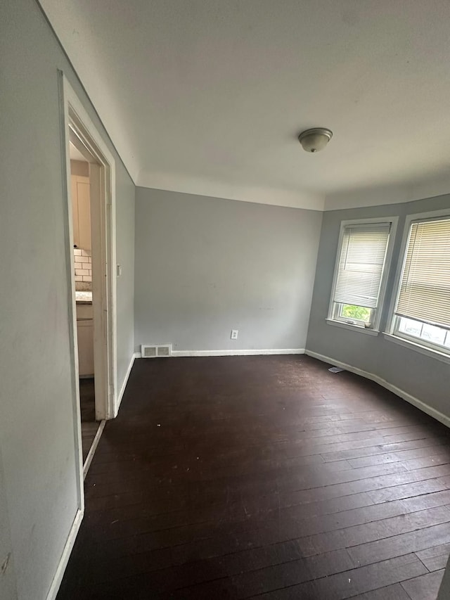 empty room featuring dark hardwood / wood-style flooring