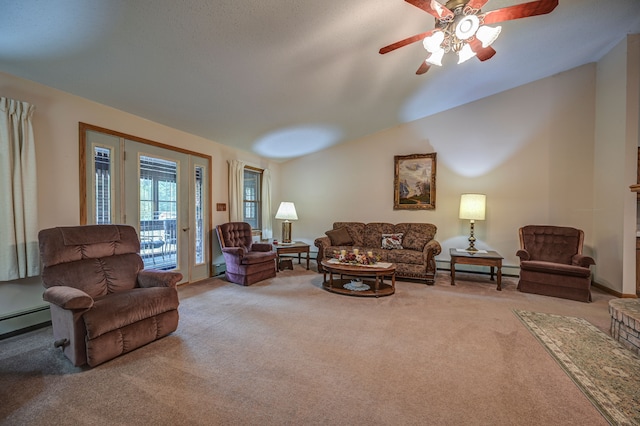 carpeted living room with ceiling fan, vaulted ceiling, and a baseboard heating unit