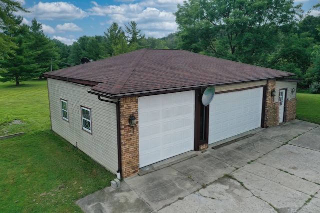 garage featuring a lawn