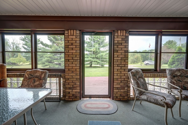 doorway to outside featuring carpet and wood ceiling