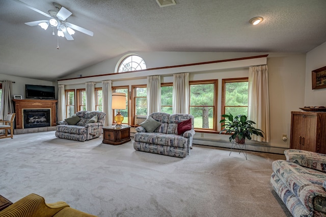 carpeted living room with ceiling fan, a baseboard radiator, a healthy amount of sunlight, and lofted ceiling